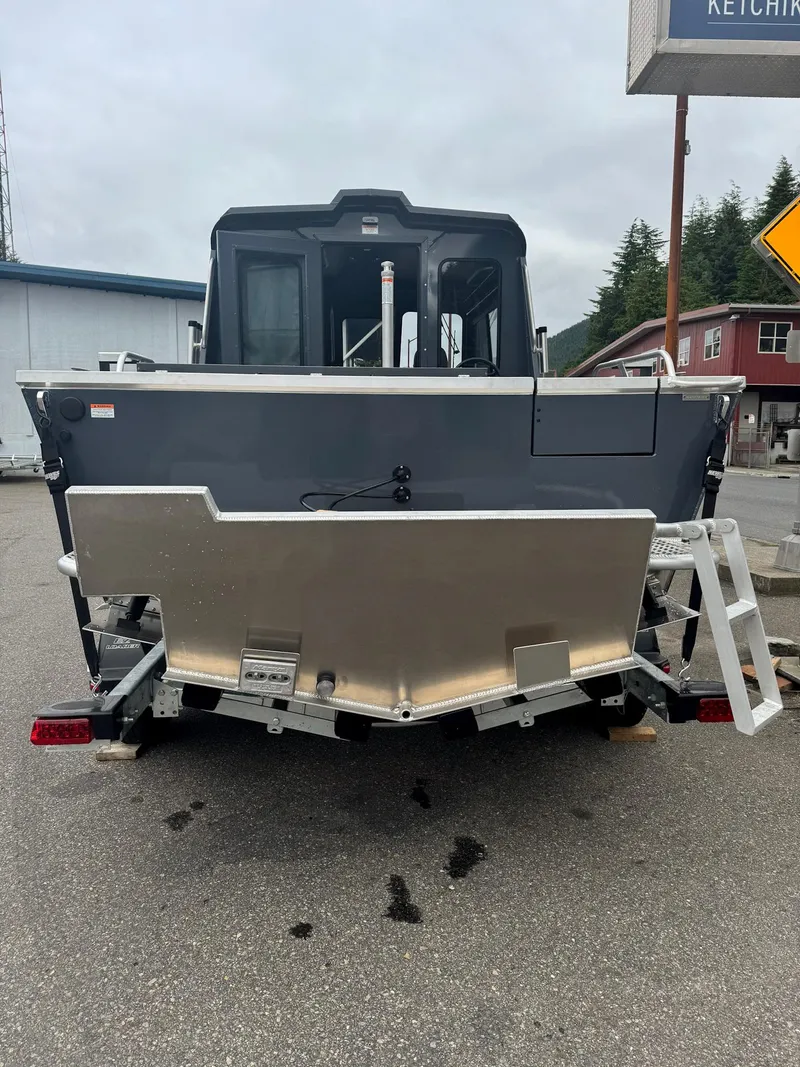 Slide: The Image of 2024 Hewescraft 220 Ocean Pro ET HT boat, rear view, parked on pavement. - 3