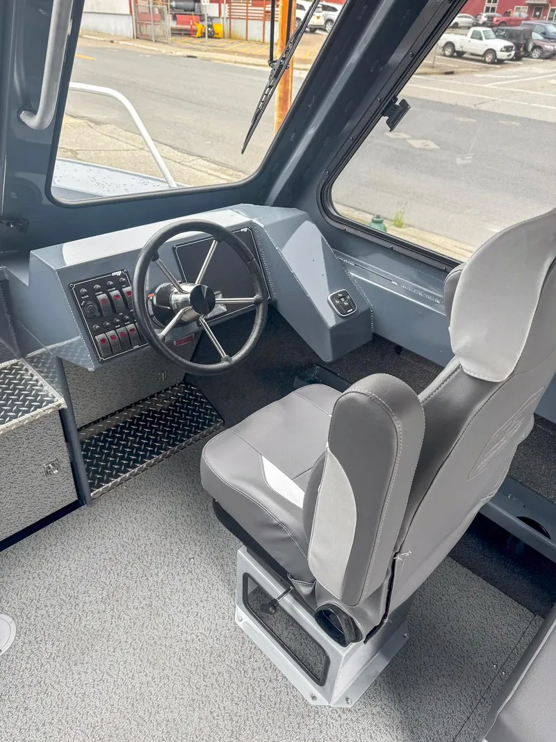 Slide: The Image of 2024 Hewescraft 220 Ocean Pro ET HT interior with steering wheel and captain's chair. - 5