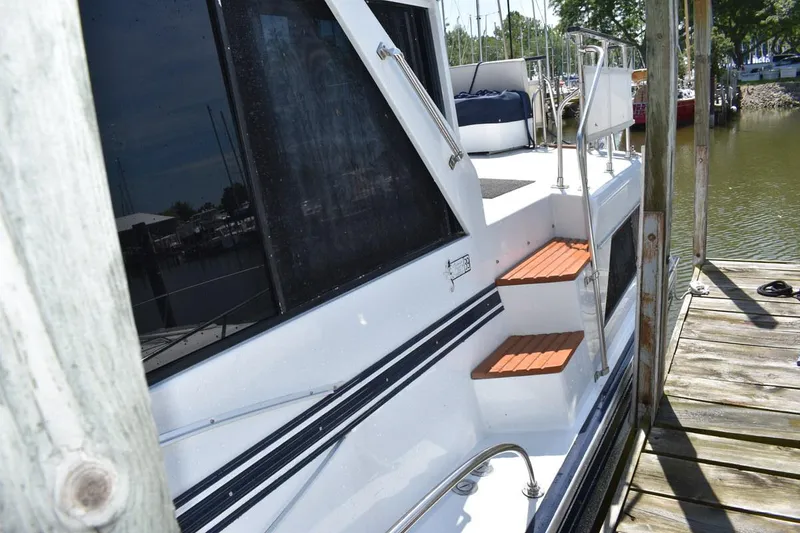 Slide: The Image of 1985 Marinette 39 Double Cabin yacht docked with wooden steps and railing. - 12