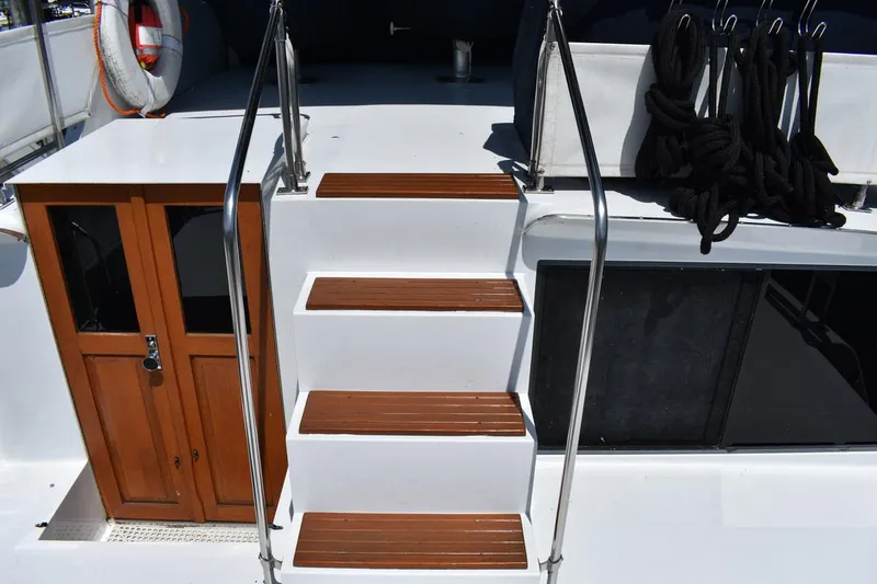 Slide: The Image of Staircase on 1985 Marinette 39 Double Cabin yacht with wooden steps and safety rails. - 33