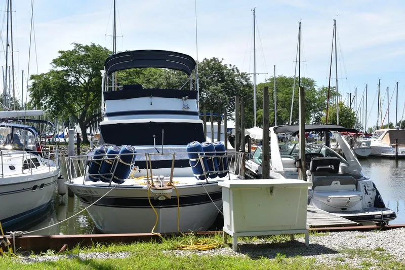 Slide: The Image of 1985 Marinette 39 Double Cabin yacht docked at a marina, surrounded by other boats. - 2