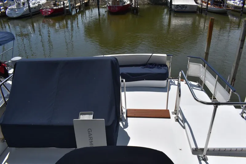 Slide: The Image of 1985 Marinette 39 Double Cabin yacht deck with seating, docked at marina. - 24