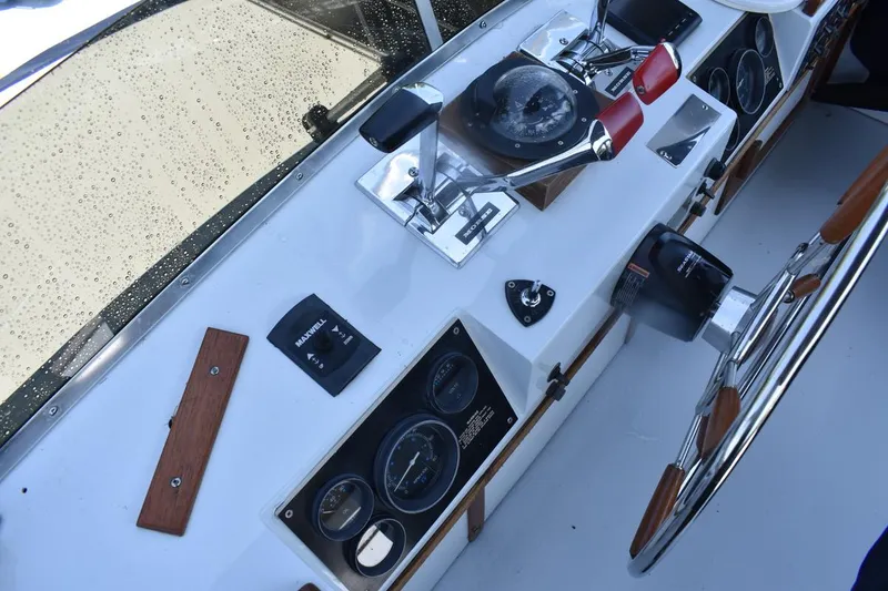 Slide: The Image of 1985 Marinette 39 Double Cabin helm with controls, gauges, and steering wheel. - 28