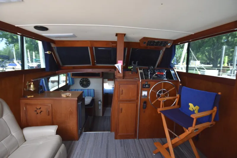 Slide: The Image of 1985 Marinette 39 Double Cabin interior with helm, wooden cabinetry, and seating. - 43