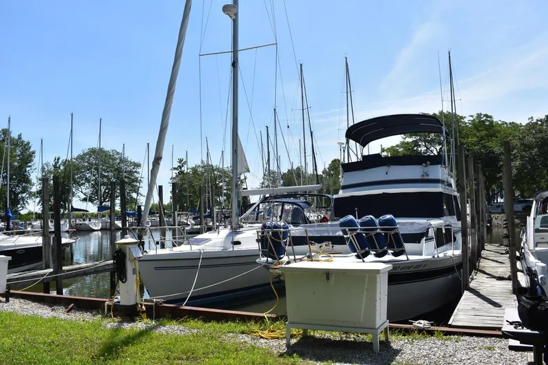 Slide: The Image of 1985 Marinette 39 Double Cabin yacht docked at a marina on a sunny day. - 4