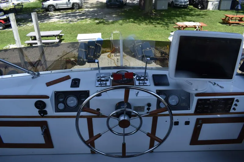 Slide: The Image of Helm of 1985 Marinette 39 Double Cabin with steering wheel and navigation instruments. - 27