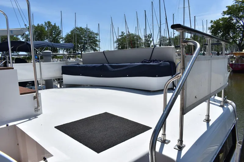 Slide: The Image of 1985 Marinette 39 Double Cabin yacht deck with seating, docked at marina. - 13