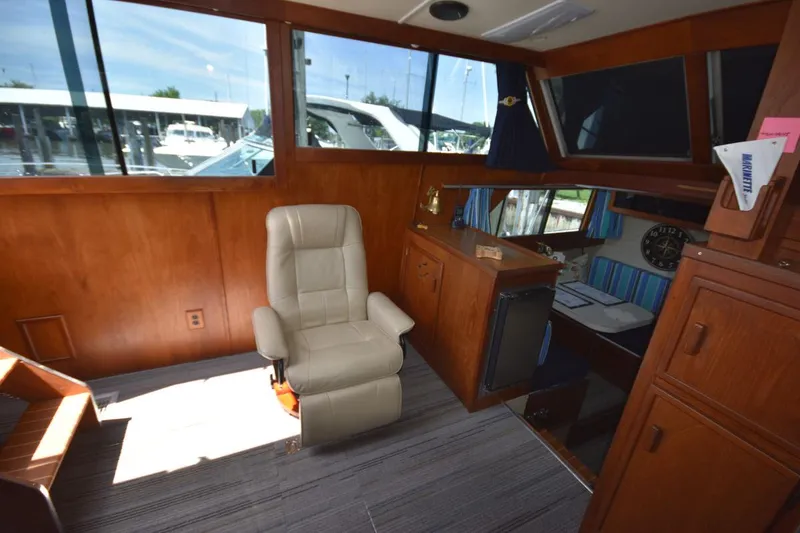 Slide: The Image of Interior of 1985 Marinette 39 Double Cabin with leather chair and wooden cabinetry. - 41