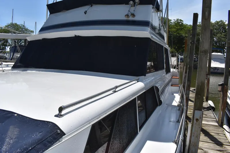 Slide: The Image of 1985 Marinette 39 Double Cabin yacht docked at marina, side view. - 9