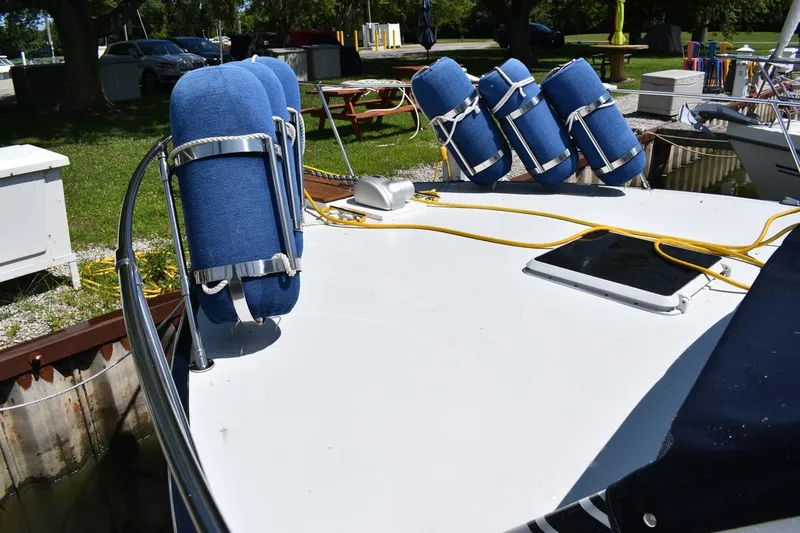 Slide: The Image of 1985 Marinette 39 Double Cabin boat deck with blue fenders and yellow ropes. - 5
