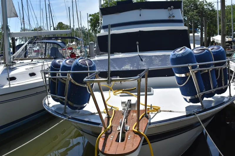 Slide: The Image of 1985 Marinette 39 Double Cabin yacht docked with blue fenders and mooring lines. - 3