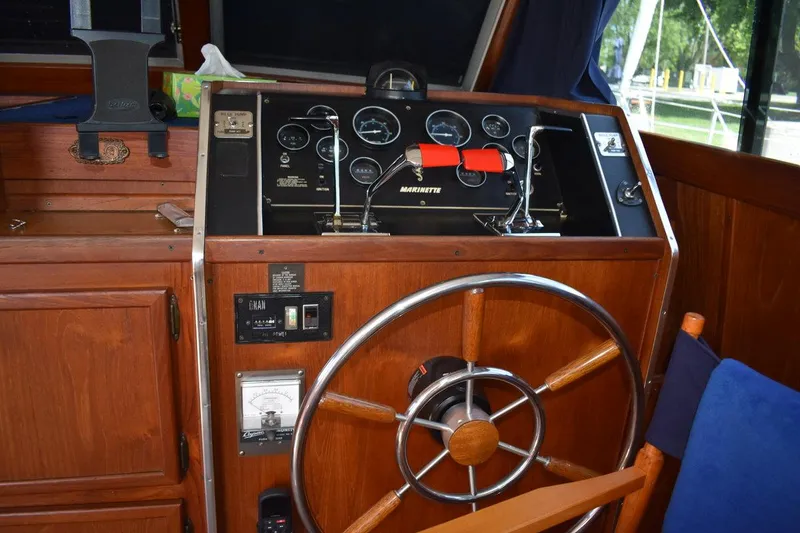 Slide: The Image of 1985 Marinette 39 Double Cabin helm with wooden wheel and control panel. - 36