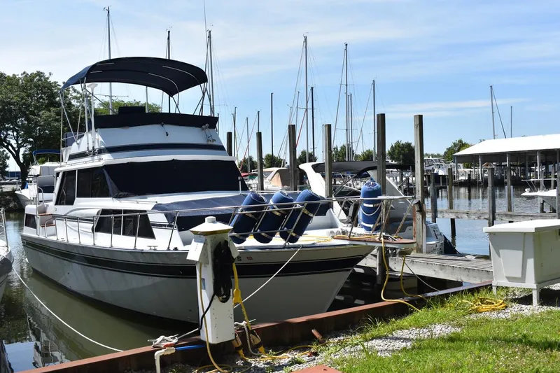 The Image of 1985 Marinette 39 Double Cabin yacht docked at a marina with clear skies. - 0
