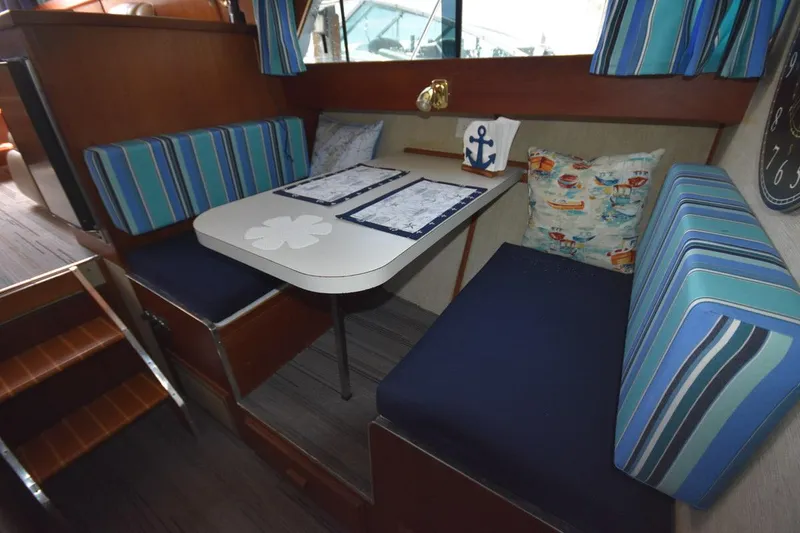 Slide: The Image of 1985 Marinette 39 Double Cabin interior with striped seating and nautical decor. - 47