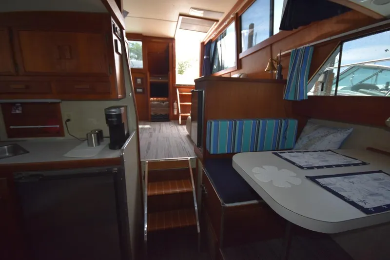 Slide: The Image of 1985 Marinette 39 Double Cabin interior with wood finish and dining area. - 48