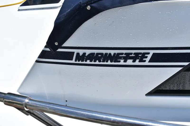 Slide: The Image of 1985 Marinette 39 Double Cabin boat with logo and railing detail. - 7