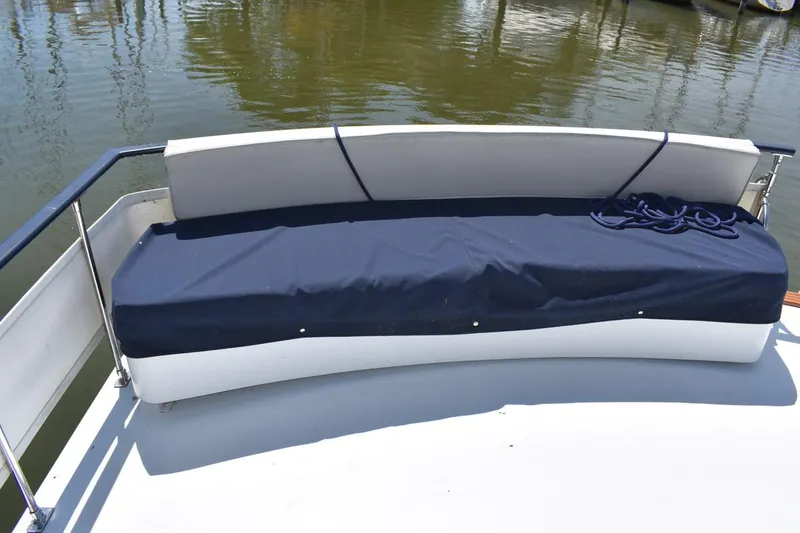 Slide: The Image of 1985 Marinette 39 Double Cabin boat with blue-covered seating on deck. - 23