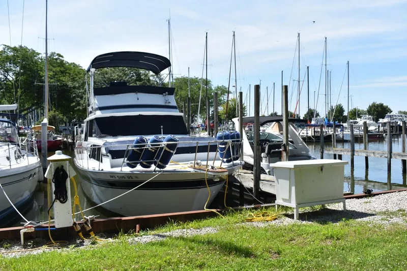Slide: The Image of 1985 Marinette 39 Double Cabin docked at a marina with sailboats. - 1
