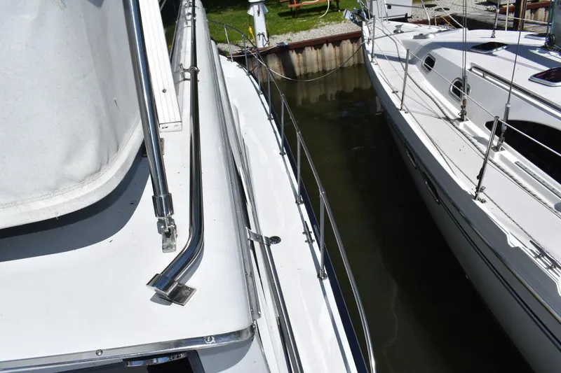 Slide: The Image of 1985 Marinette 39 Double Cabin yacht docked beside another boat. - 20