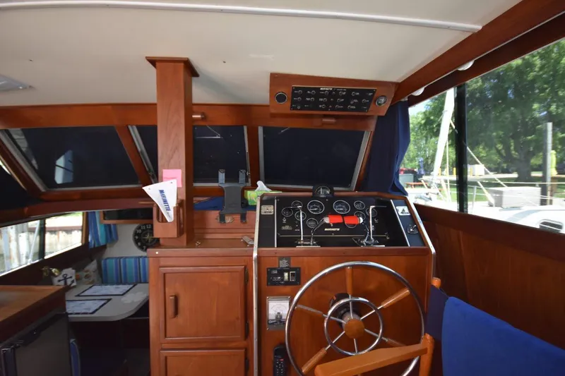 Slide: The Image of 1985 Marinette 39 Double Cabin helm with wooden interior and navigation instruments. - 44