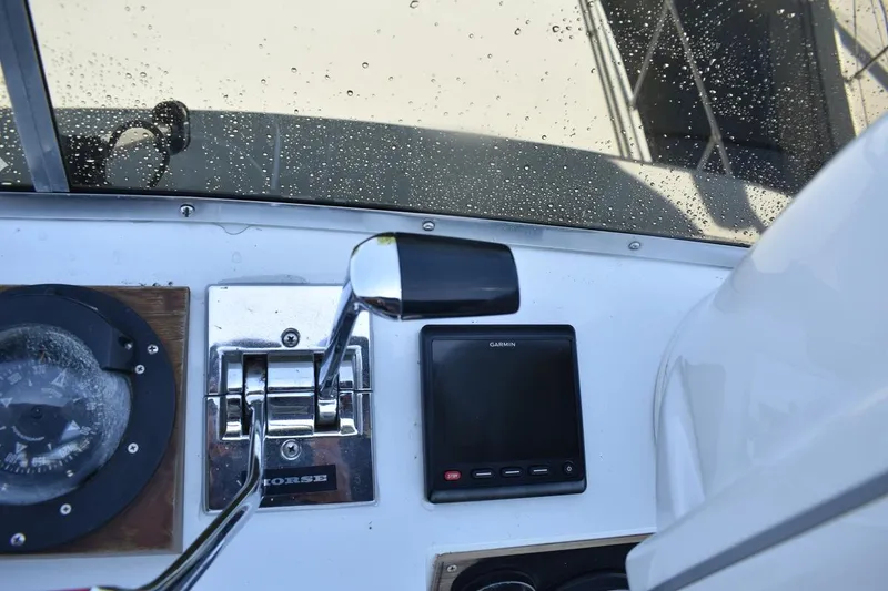 Slide: The Image of Control panel of a 1985 Marinette 39 Double Cabin boat with compass and Garmin display. - 30