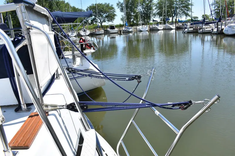 Slide: The Image of 1985 Marinette 39 Double Cabin docked with ropes, surrounded by other boats in a marina. - 15
