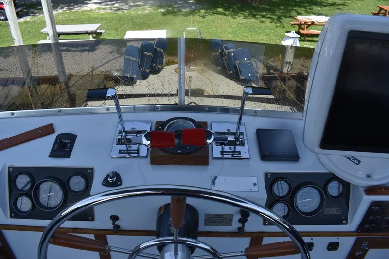 Slide: The Image of 1985 Marinette 39 Double Cabin helm with gauges, controls, and steering wheel. - 26