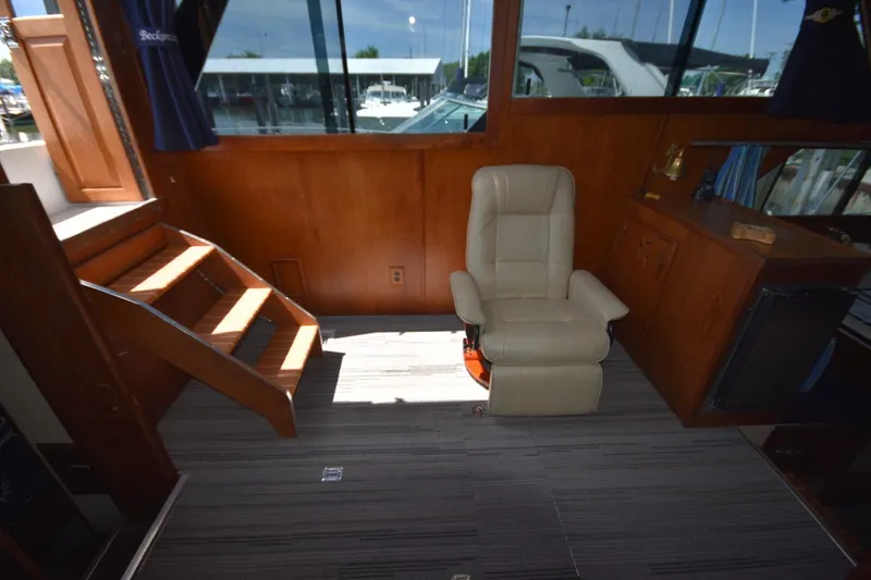 Slide: The Image of Interior of 1985 Marinette 39 Double Cabin with beige chair and wooden stairs. - 40