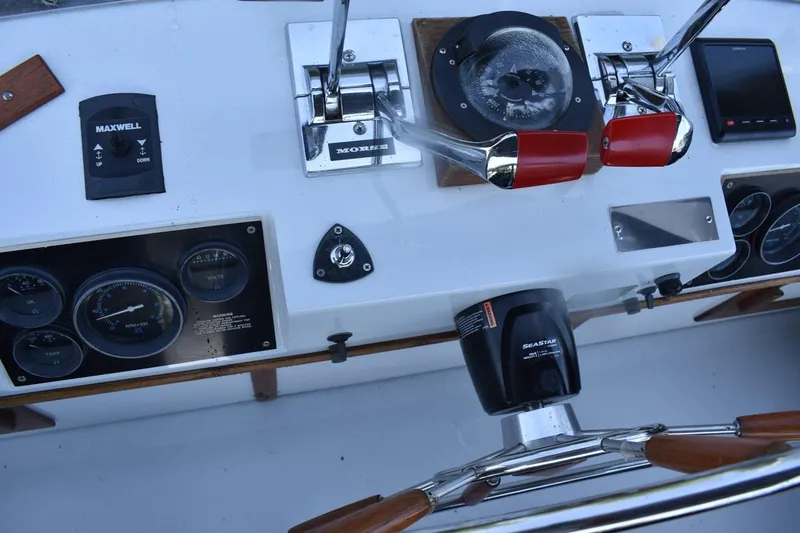 Slide: The Image of Control panel of a 1985 Marinette 39 Double Cabin boat with gauges and steering wheel. - 29