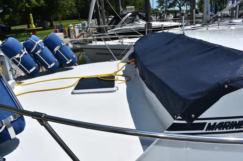 Slide: The Image of 1985 Marinette 39 Double Cabin yacht deck with blue fenders and cover. - 6