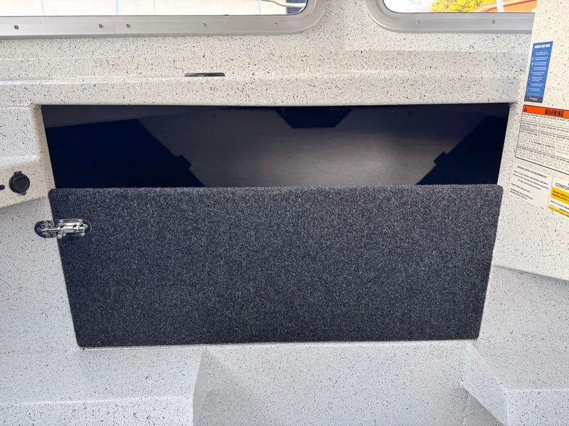 Slide: The Image of 2025 KingFisher 2825 Coastal Express interior storage compartment with open hatch. - 14