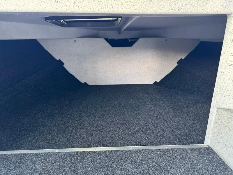 Slide: The Image of Interior cabin space of 2025 KingFisher 2825 Coastal Express boat, featuring carpeted flooring. - 15