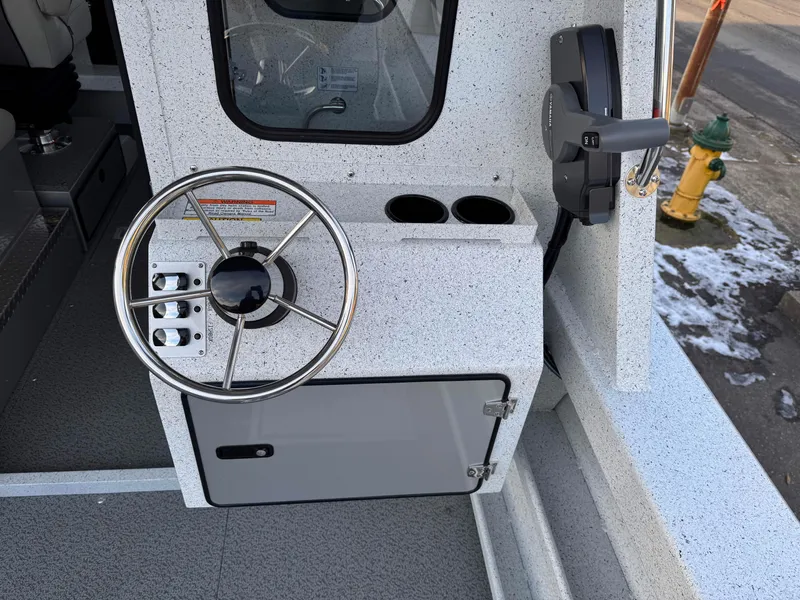 Slide: The Image of Steering console of 2025 KingFisher 2825 Coastal Express boat with controls and cup holders. - 17