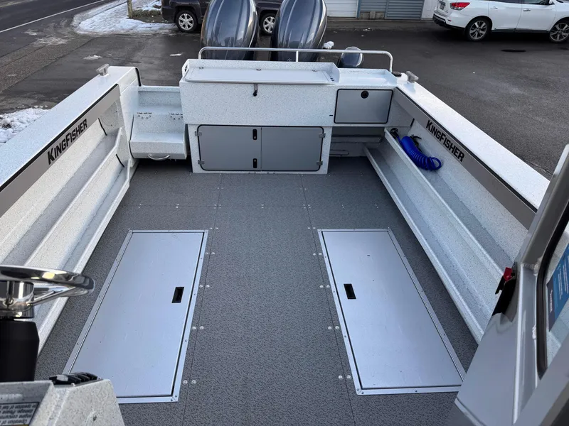 Slide: The Image of 2025 KingFisher 2825 Coastal Express boat interior with storage compartments and clean deck. - 18