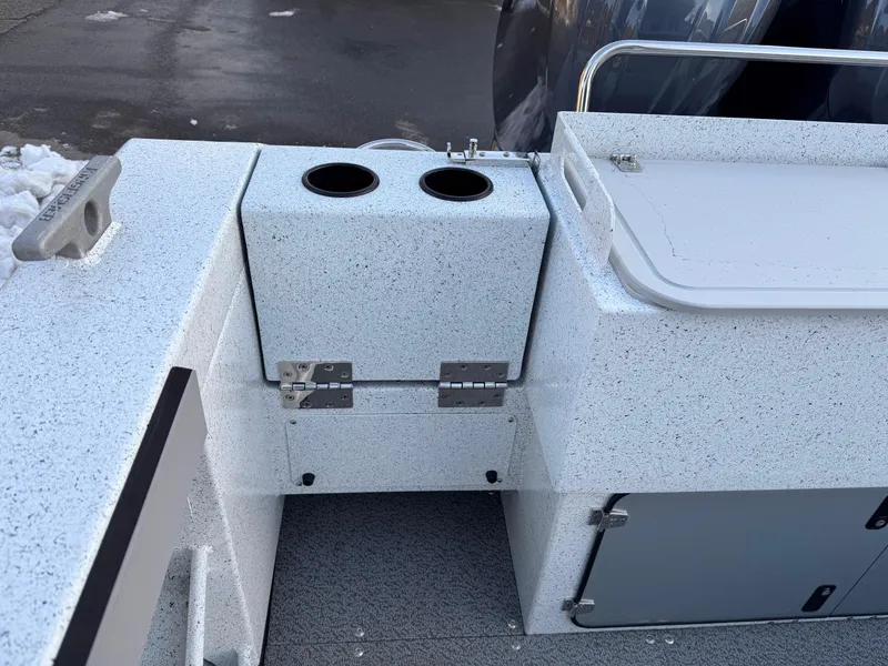 Slide: The Image of 2025 KingFisher 2825 Coastal Express boat interior with storage compartments and cup holders. - 19