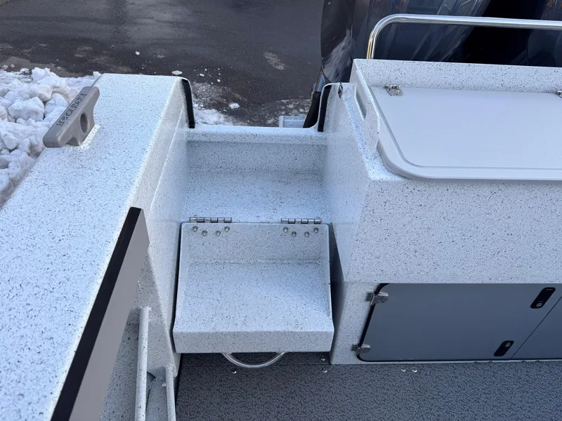 Slide: The Image of KingFisher 2825 Coastal Express 2025 boat deck with storage compartments and snowy surroundings. - 20