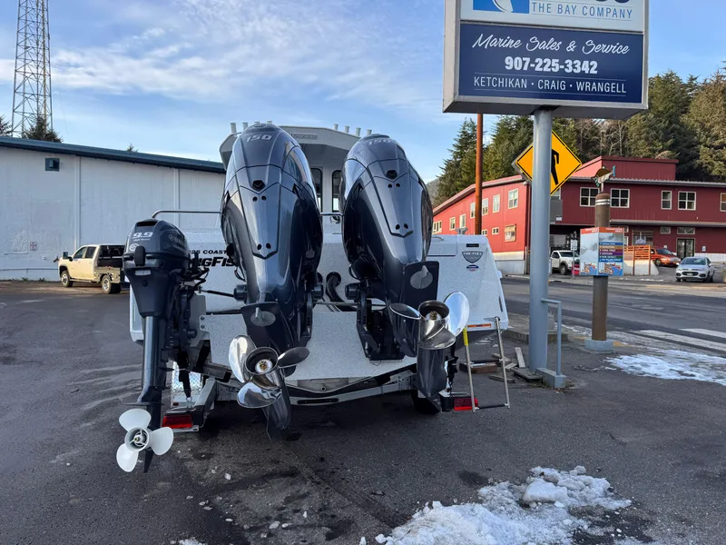 Slide: The Image of 2025 KingFisher 2825 Coastal Express boat with powerful outboard motors at a marine service center. - 4