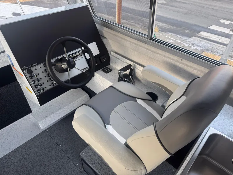 Slide: The Image of 2025 KingFisher 2825 Coastal Express boat interior with steering wheel and captain's seat. - 6