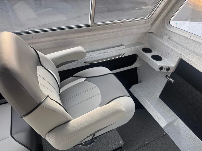 Slide: The Image of 2025 KingFisher 2825 Coastal Express interior with comfortable seating and cup holders. - 7