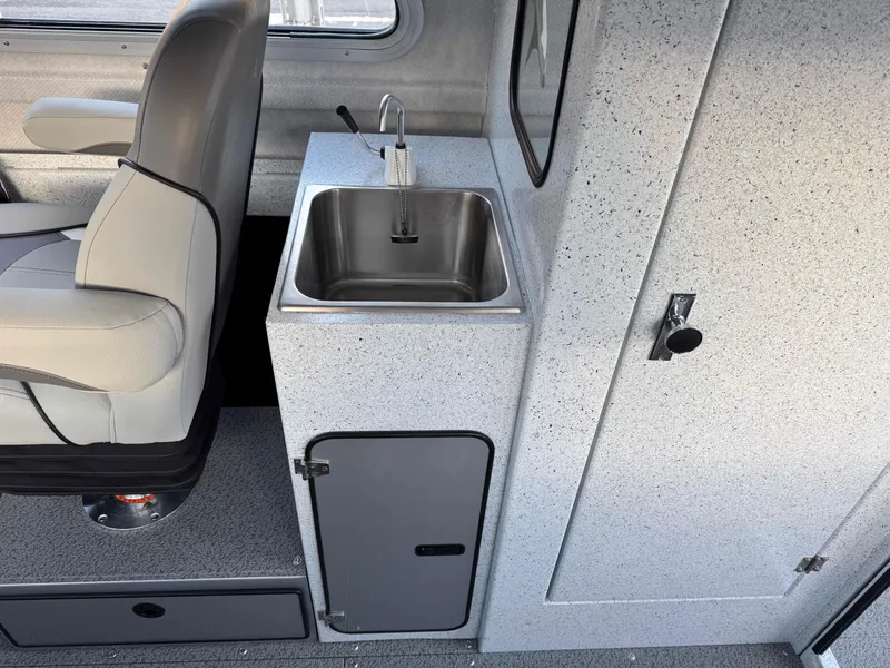 Slide: The Image of Interior of 2025 KingFisher 2825 Coastal Express with sink and seating. - 9