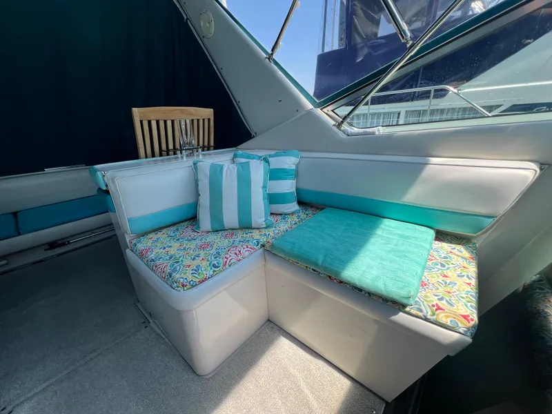 Slide: The Image of Interior of 1988 Wellcraft 3400 Grand Sport with colorful seating and striped cushions. - 12