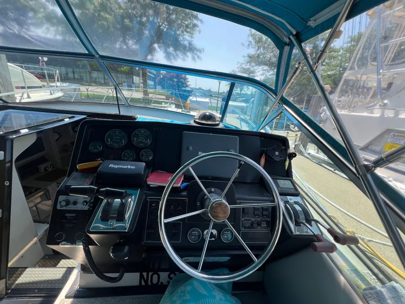 Slide: The Image of Cockpit view of 1988 Wellcraft 3400 Grand Sport boat with steering wheel and controls. - 13