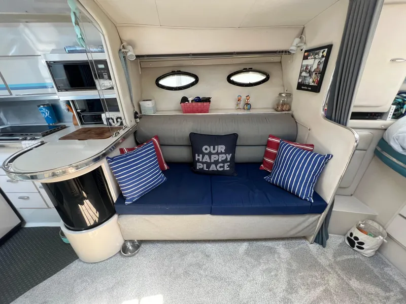 Slide: The Image of Interior of 1988 Wellcraft 3400 Grand Sport with cozy seating and nautical decor. - 19