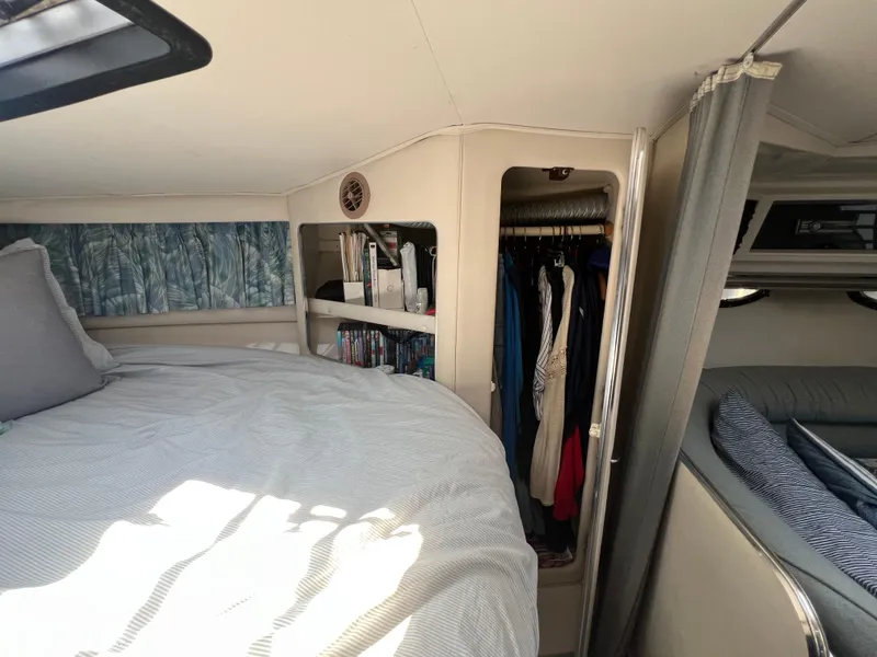 Slide: The Image of 1988 Wellcraft 3400 Grand Sport cabin interior with bed, closet, and storage shelves. - 21