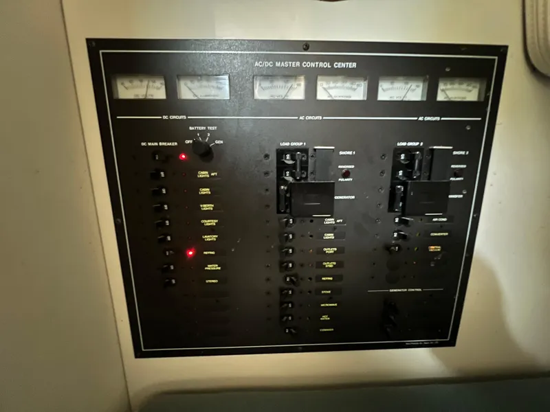 Slide: The Image of Control panel of a 1988 Wellcraft 3400 Grand Sport boat, featuring AC/DC circuits. - 25