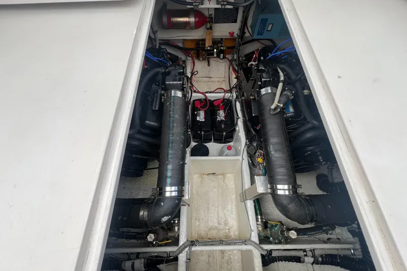 Slide: The Image of Engine compartment of a 1988 Wellcraft 3400 Grand Sport boat, showcasing dual engines and wiring. - 27