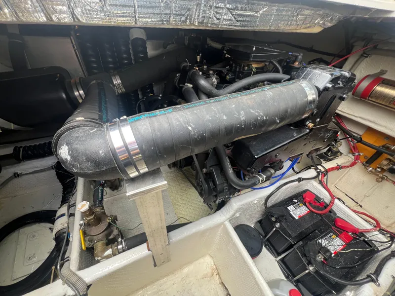 Slide: The Image of Engine compartment of a 1988 Wellcraft 3400 Grand Sport boat, showing hoses and batteries. - 28
