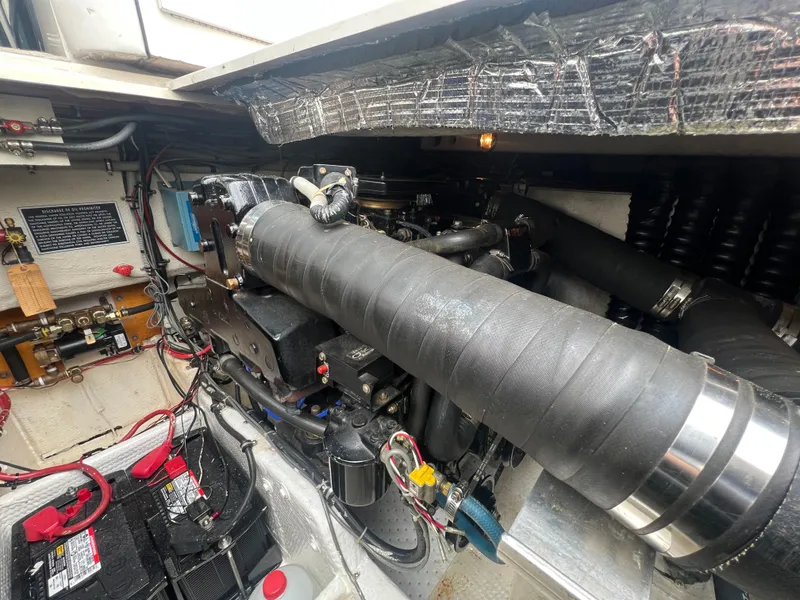 Slide: The Image of Engine compartment of 1988 Wellcraft 3400 Grand Sport boat, showing detailed mechanical components. - 29