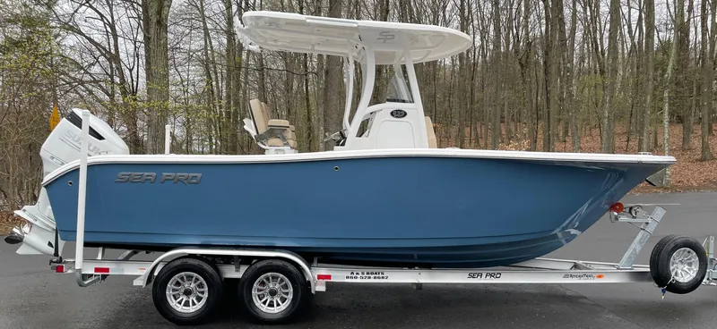 Slide: The Image of 2022 Sea Pro 239 Center Console boat on trailer, parked in wooded area. - 3
