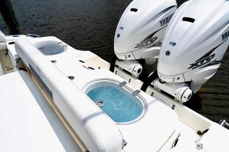 Slide: The Image of 2024 Cobia 350 boat with dual Yamaha XTO outboard engines and livewell on deck. - 11